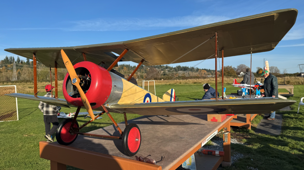 A 1/3 scale Sopwith Pup sits on a table in the pits.