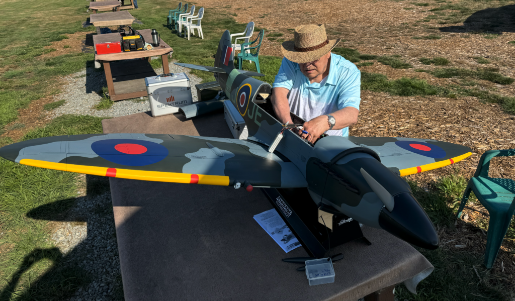 Club member George prepares his giant scale Spitfire for flight.
